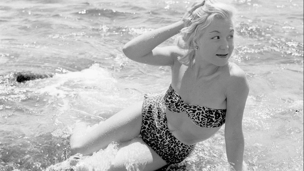 November 1955Seventeen year old American model Kim Leslie posing in the surf