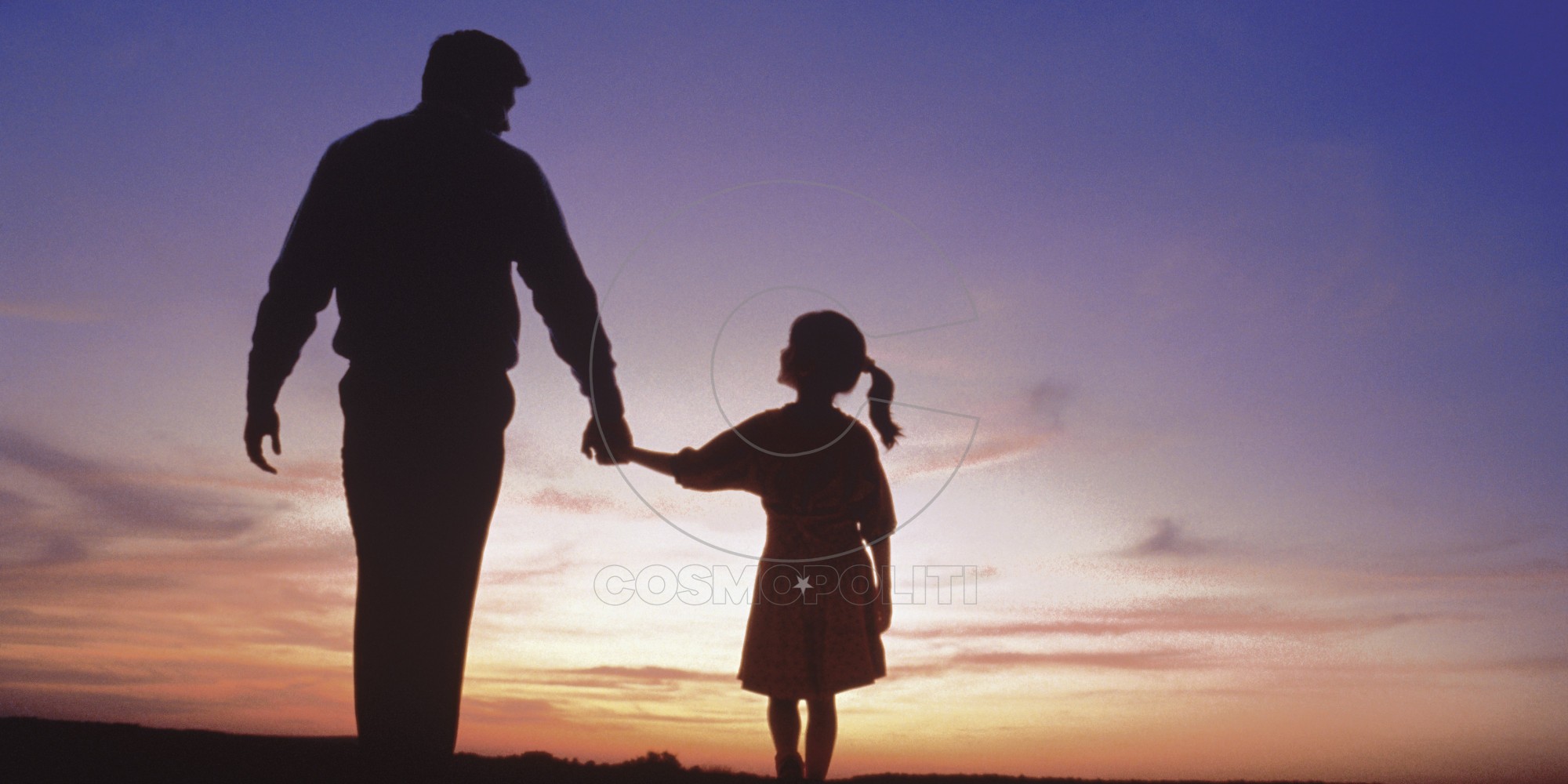 Silhouette of father and daughter walking